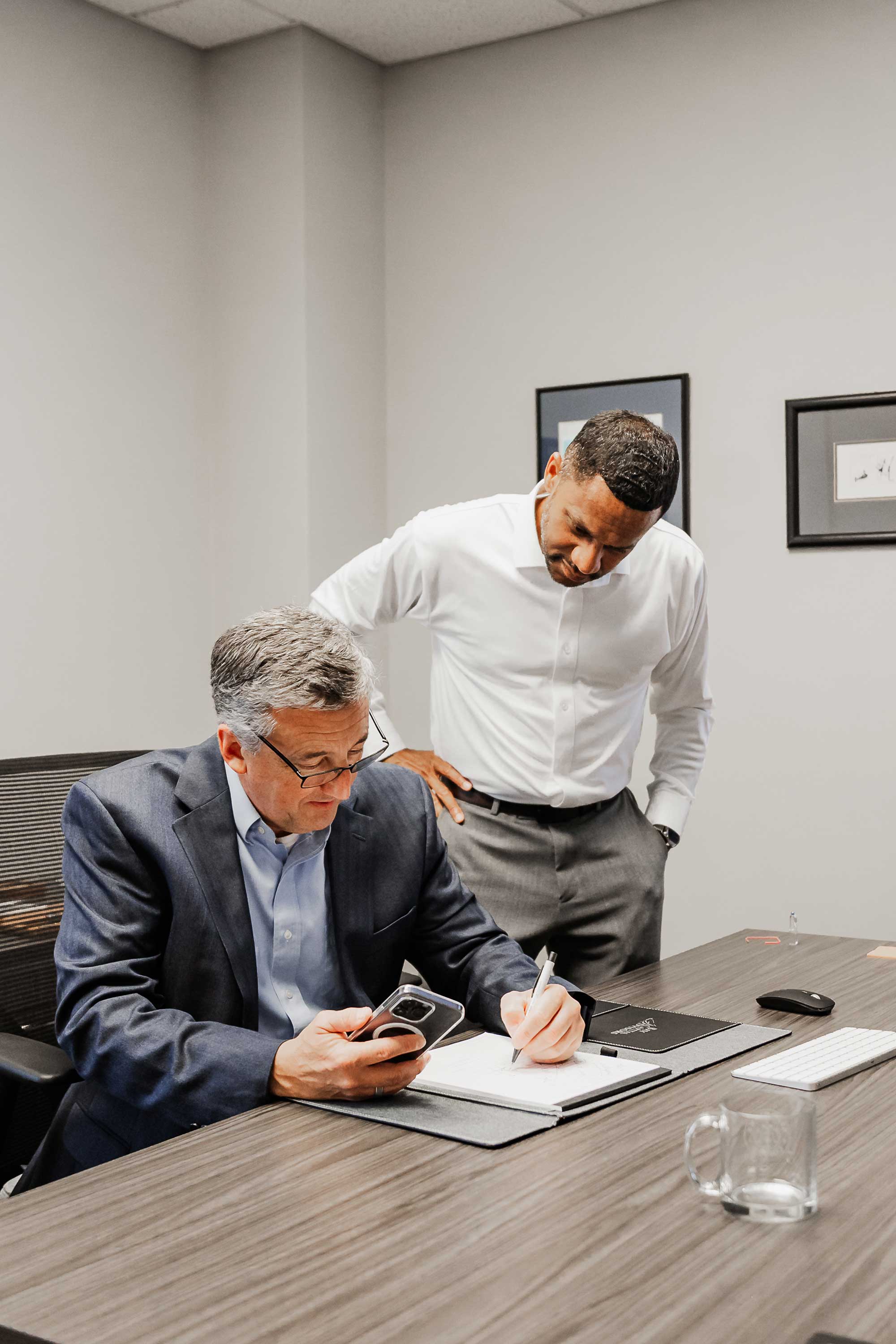 Joe Sallee and Arcelia Wicker are reviewing and signing documents | Bay Capital Advisors